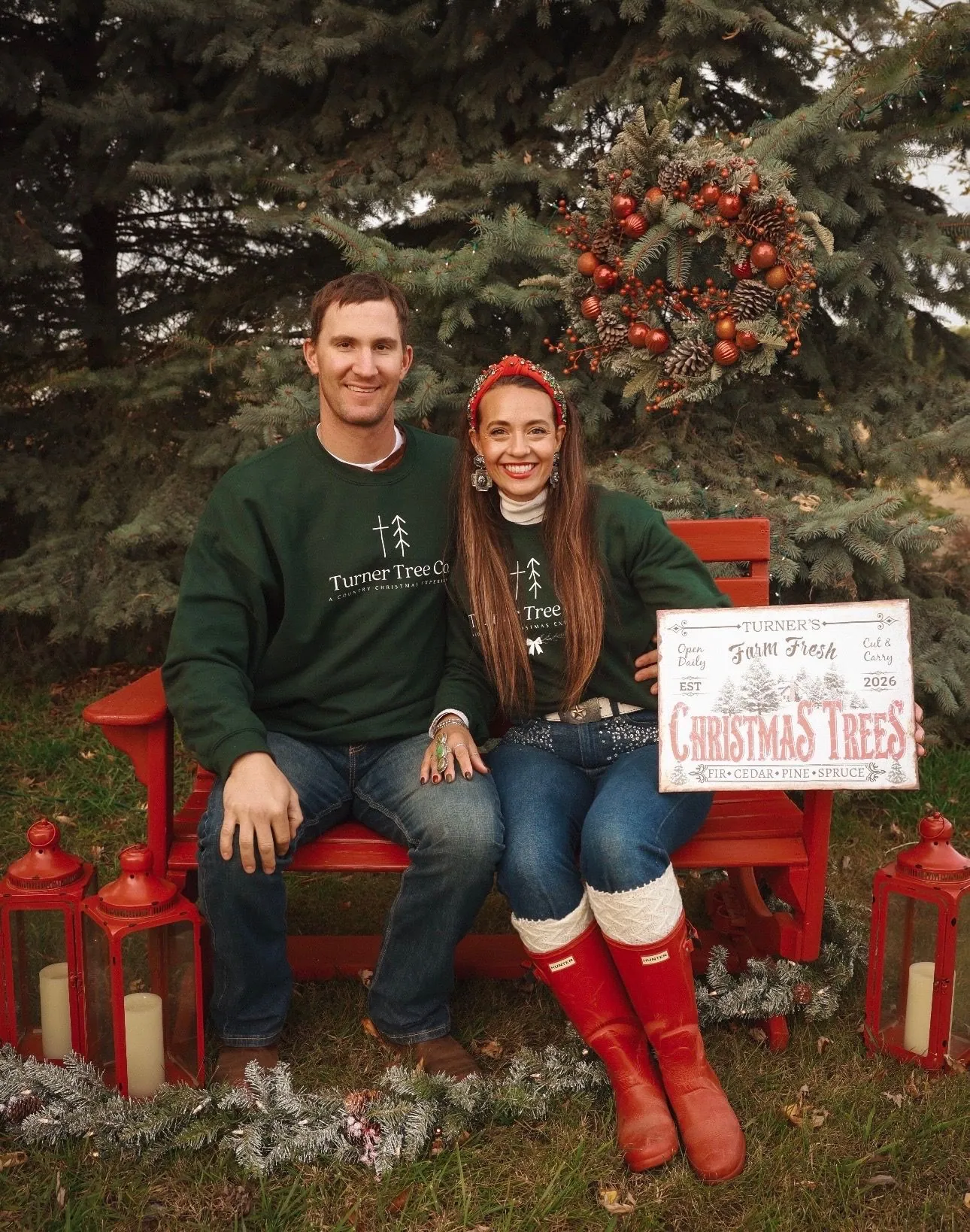 Mr. and Mrs. Turner on the red bench at the tree lot